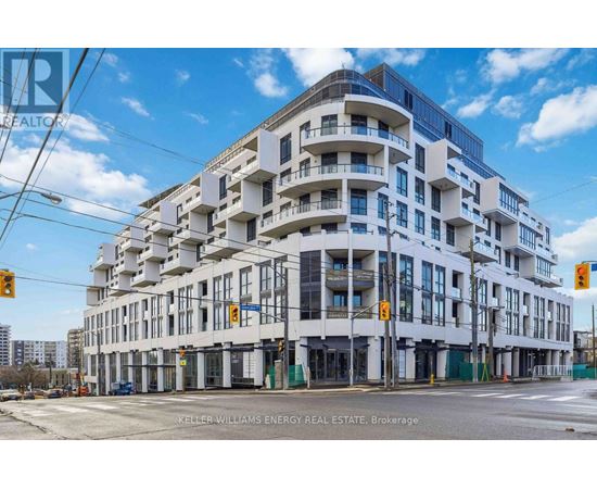 A large white building with balconies is under construction.