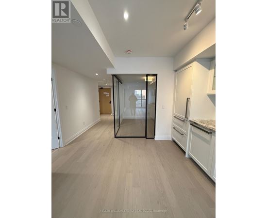 A spacious room with a glass door and a countertop.