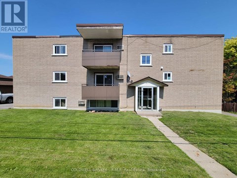 A building with a green lawn in front of it.
