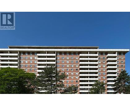 A tall building with a clear blue sky in the background.