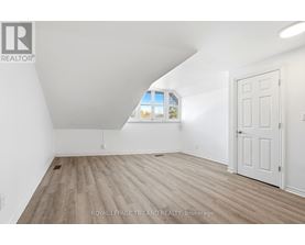 A white room with a door and a window.