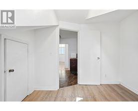 A white room with a door and a window.