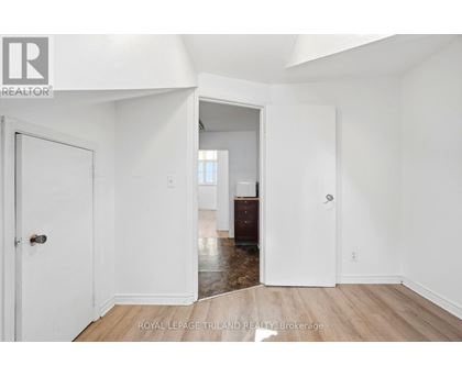 A white room with a door and a window.