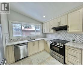 A kitchen with white cabinets and a black stove top oven.