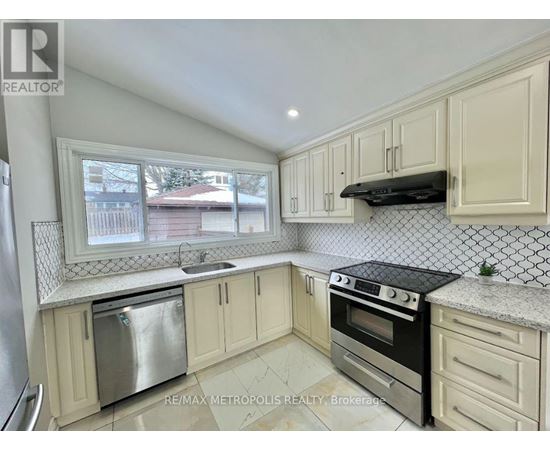 A kitchen with white cabinets and a black stove top oven.