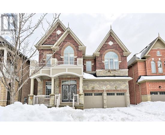 A large house with a snow-covered front yard.