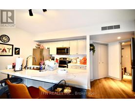A kitchen with a sink, stove, and refrigerator.