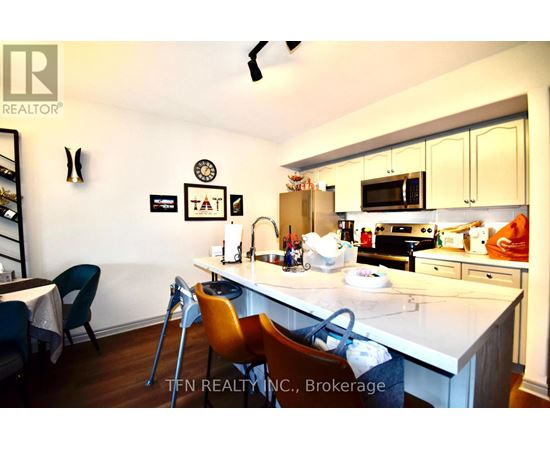 A kitchen with a white countertop and a dining table with chairs.