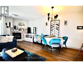 A living room with a blue couch, a white table, and a fireplace.