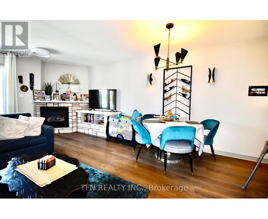 A living room with a blue couch, a white table, and a fireplace.