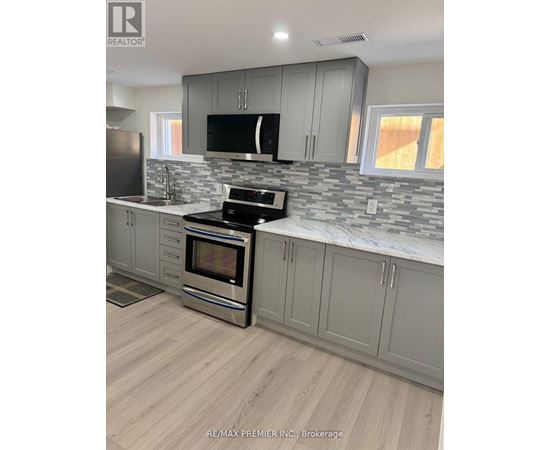 A kitchen with a stove top oven and a microwave.