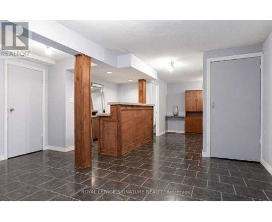 A spacious room with a wooden cabinet and a white door.