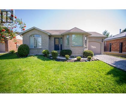 A house with a well-maintained lawn and a clear sky.