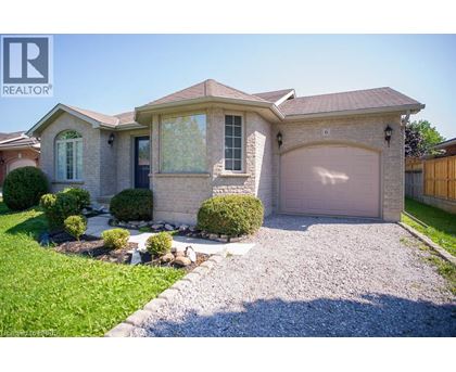 A house with a gravel driveway and a garage door.