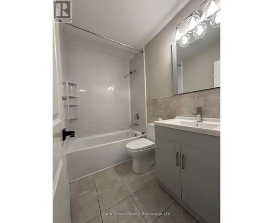 A bathroom with a white toilet, sink, and bathtub.