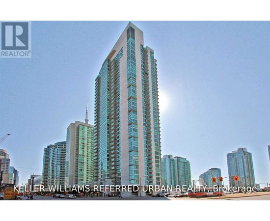 A tall building with a glass facade is the main focus of the image.