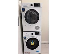 A stack of two white Genuine Whirlpool washing machines.