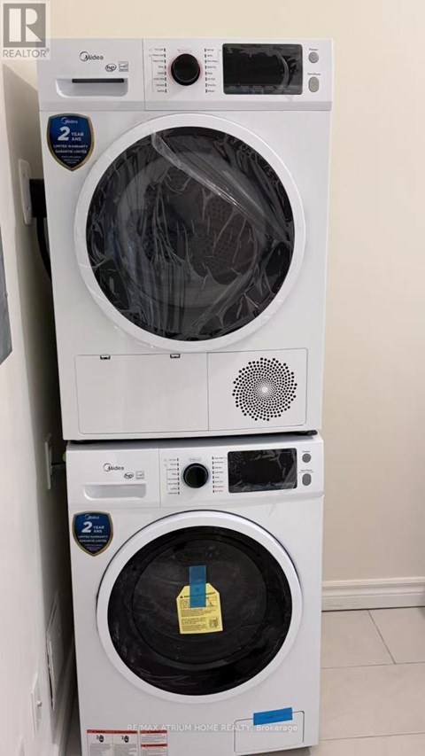A stack of two white Genuine Whirlpool washing machines.