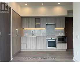 A modern kitchen with a marble backsplash and stainless steel appliances.