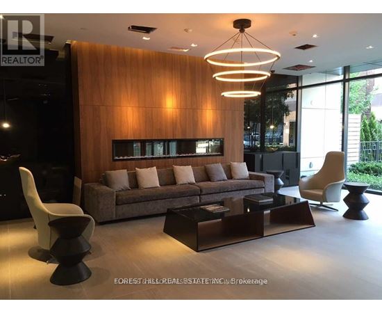 A modern living room with a brown couch and a wooden wall.