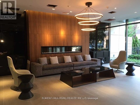 A modern living room with a brown couch and a wooden wall.
