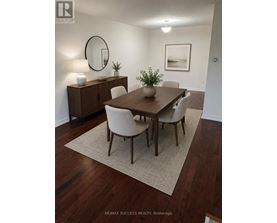 A dining room with a wooden table and chairs.