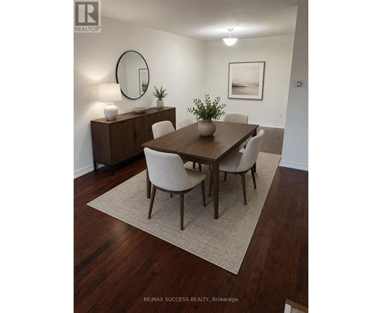 A dining room with a wooden table and chairs.