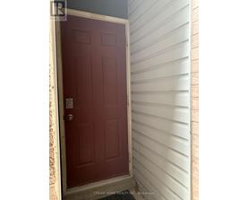 A red door with a white frame and a keypad entry system.
