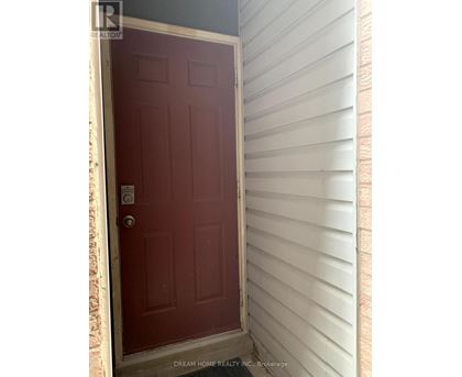 A red door with a white frame and a keypad entry system.