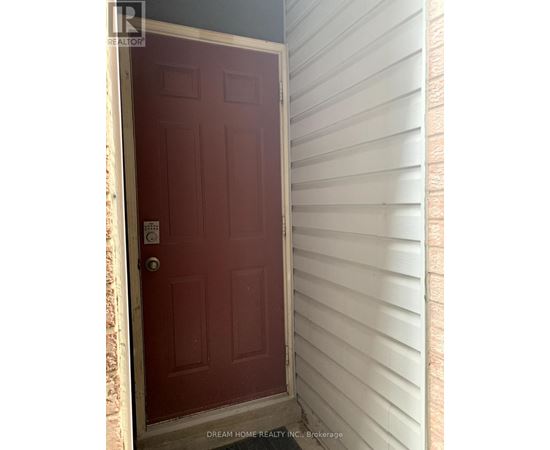 A red door with a white frame and a keypad entry system.