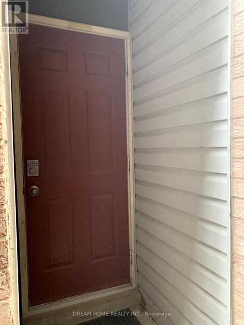 A red door with a white frame and a keypad entry system.