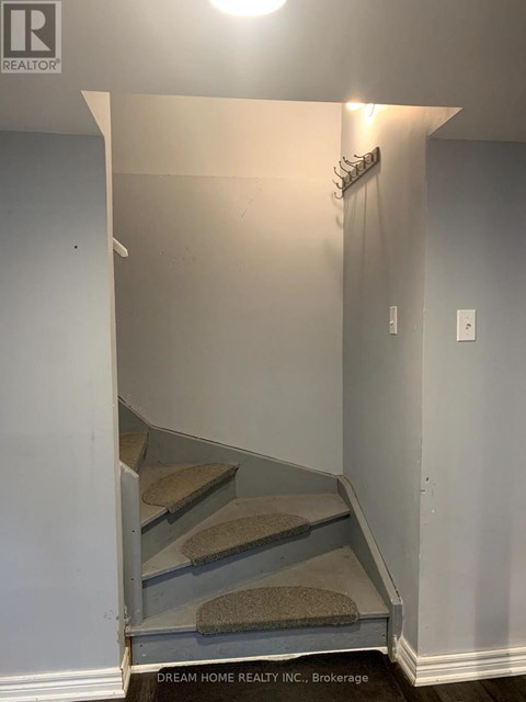 A hallway with a staircase leading to the second floor.