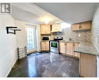 A kitchen with wooden cabinets and a granite countertop.