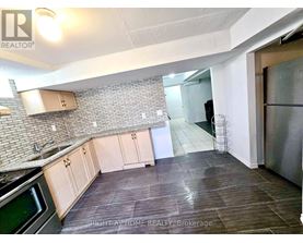 A kitchen with a stove top oven and a refrigerator.