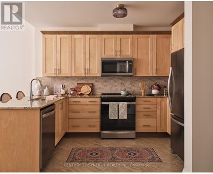 A kitchen with wooden cabinets and a rug on the floor.