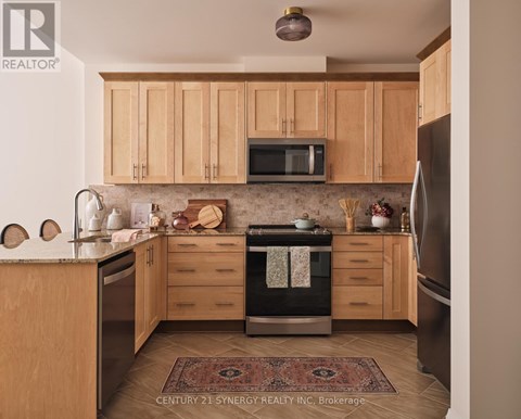 A kitchen with wooden cabinets and a rug on the floor.