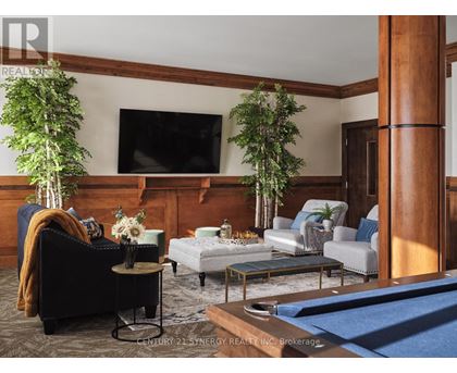 A living room with a pool table and a television.