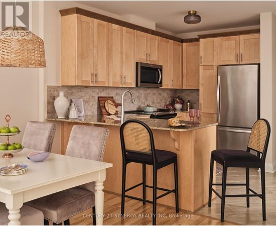 A kitchen with wooden cabinets and a white table.
