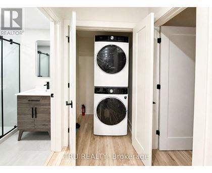 A white washer and dryer in a laundry room.