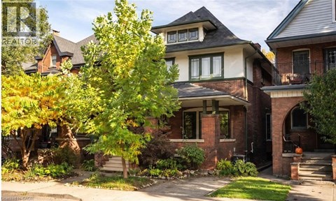 A house with a tree in front of it.