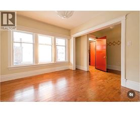 A room with wooden floors and a large window.