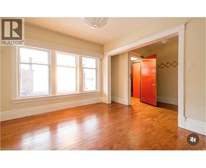 A room with wooden floors and a large window.