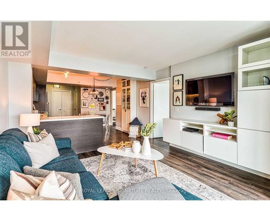 A living room with a couch, a coffee table, and a television.