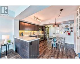 A modern kitchen with a wooden island and a dining table set up.