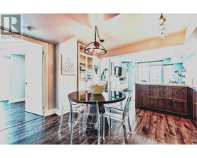 A dining room with a table set for four.