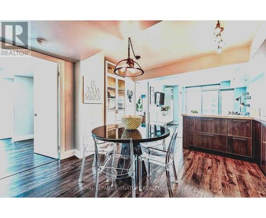 A dining room with a table set for four.