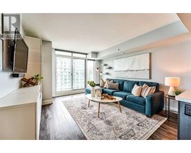A living room with a blue couch and a white coffee table.