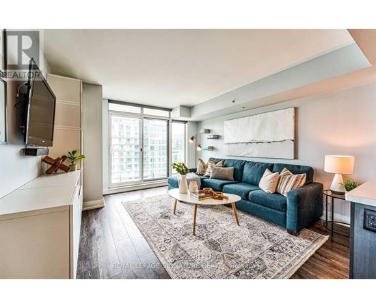 A living room with a blue couch and a white coffee table.