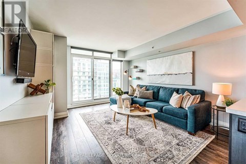 A living room with a blue couch and a white coffee table.