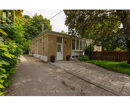 A small house with a driveway in front of it.